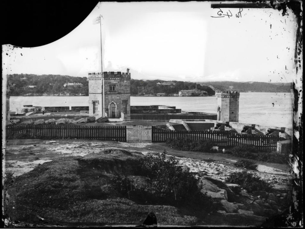 Black and white image of a historic fort on a rocky coast.
